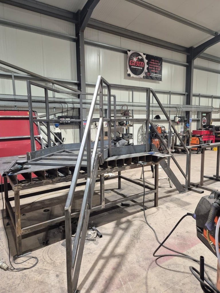 Industrial warehouse with welding equipment and metal frame structures under construction in progress